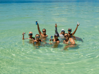 A group of Danger Charters guests enjoying a sunny Summer afternoon on a sandbar in Key West