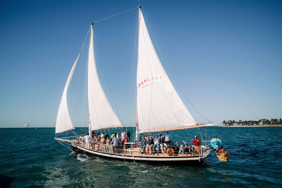 Group aboard a schooner enjoying a sailing charter in Key West with Danger Charters