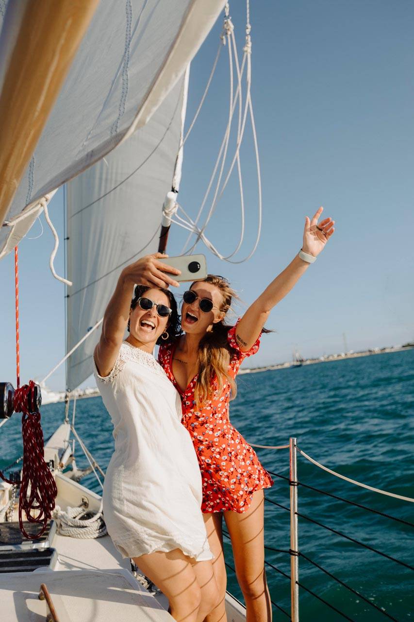 Two female friends take a selfie while sailing on a schooner charter in Key West, FL
