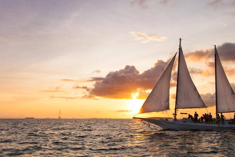 Group aboard a schooner enjoying a sunset cruise in Key West with Danger Charters