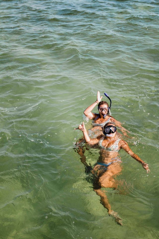 Two women in bikinis snorkeling in Key West