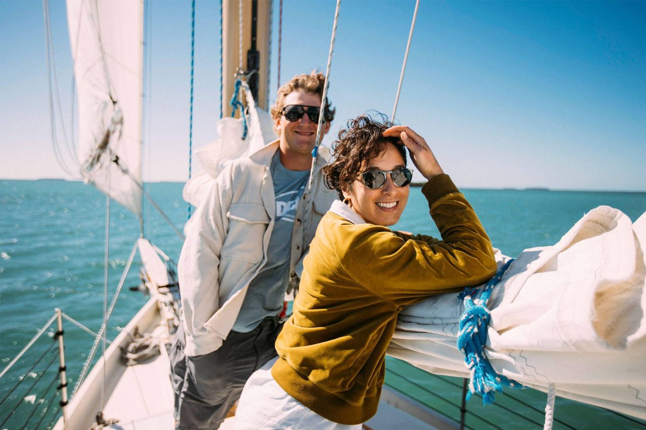 Couple smiling and enjoying a private sailing charter in Key West with Danger Charters