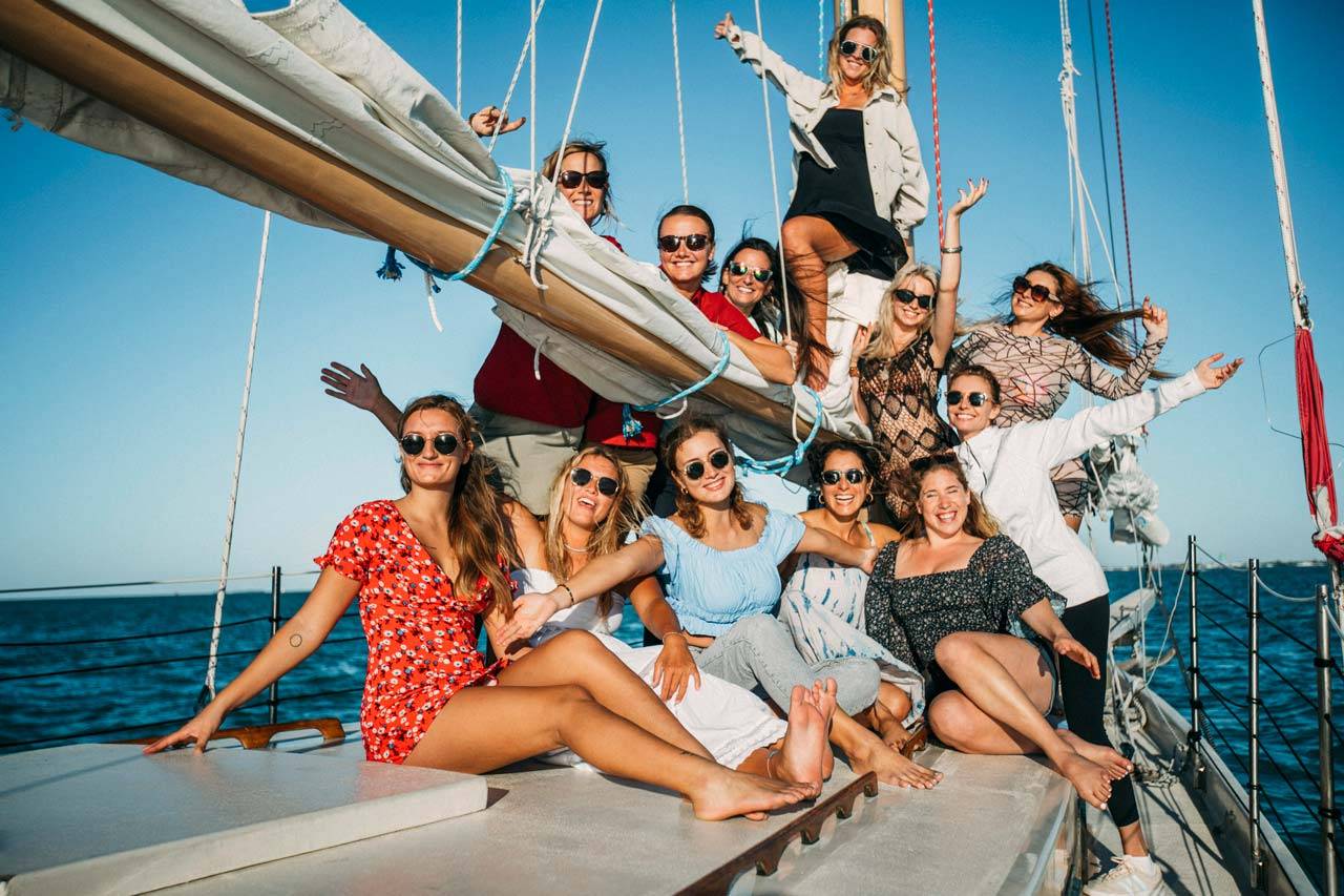 A group of young women pose for a photo while on a sailing charter with Danger Charters in Key West, FL