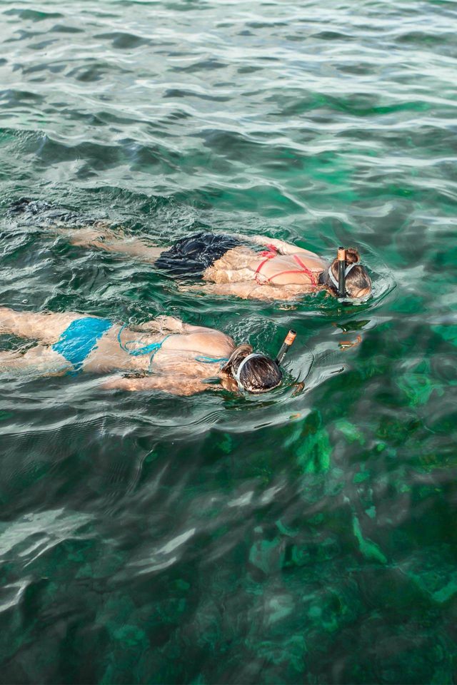 Two women in bikinis snorkeling in Key West