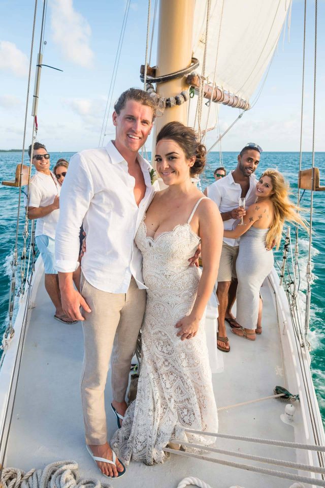 A couple and friends enjoy a sailboat wedding celebration aboard a schooner in Key West