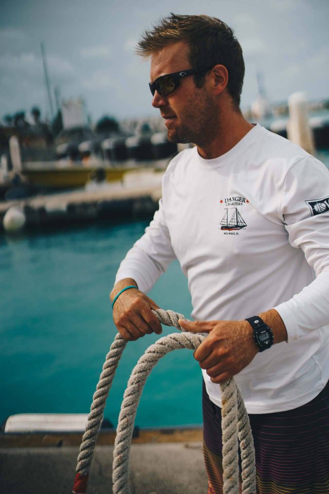 A Danger Charters crew member unties a rope