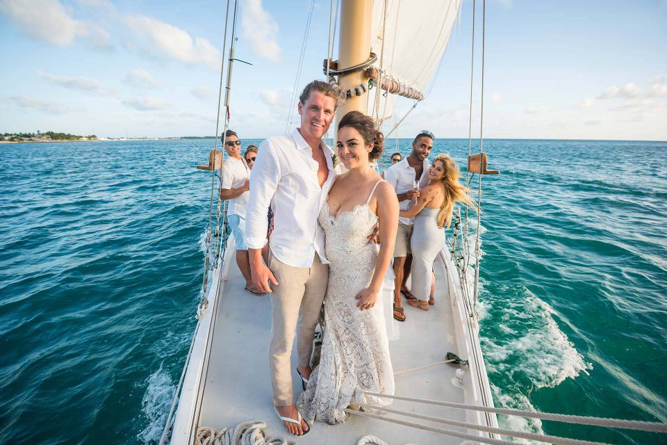 A couple and friends enjoy a sailboat wedding celebration aboard a schooner in Key West