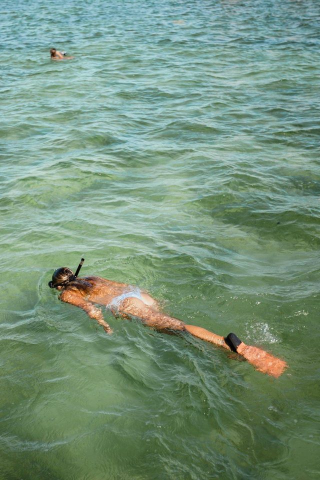 Woman in a blue bikini snorkeling in Key West, FL