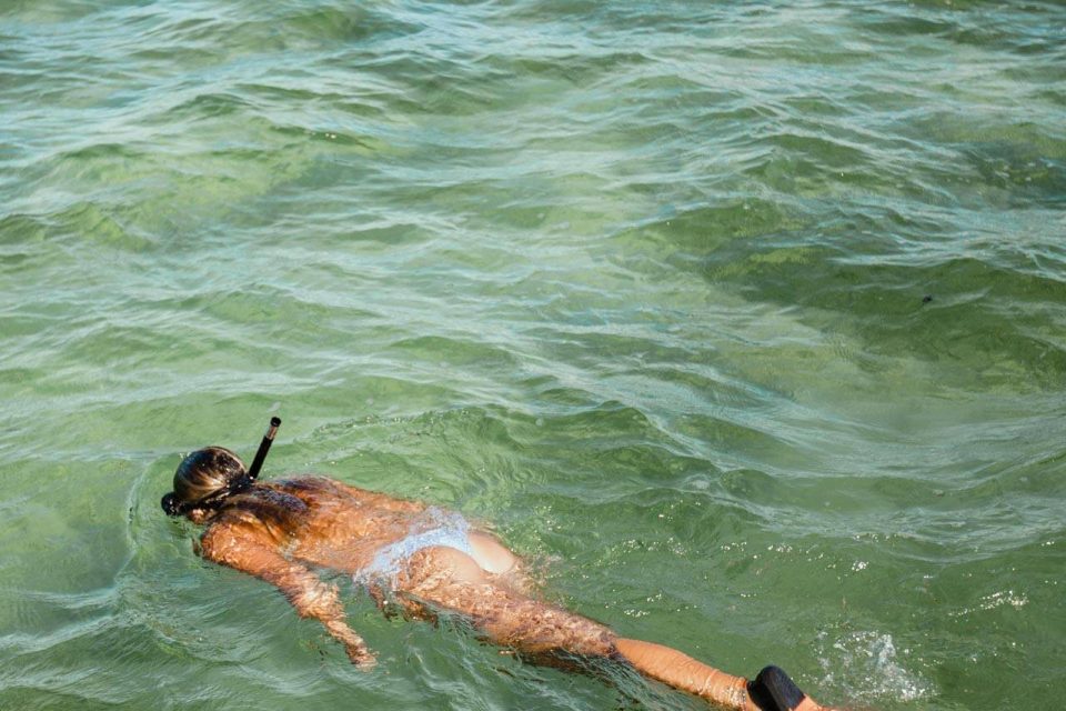 Woman in a blue bikini snorkeling in Key West, FL