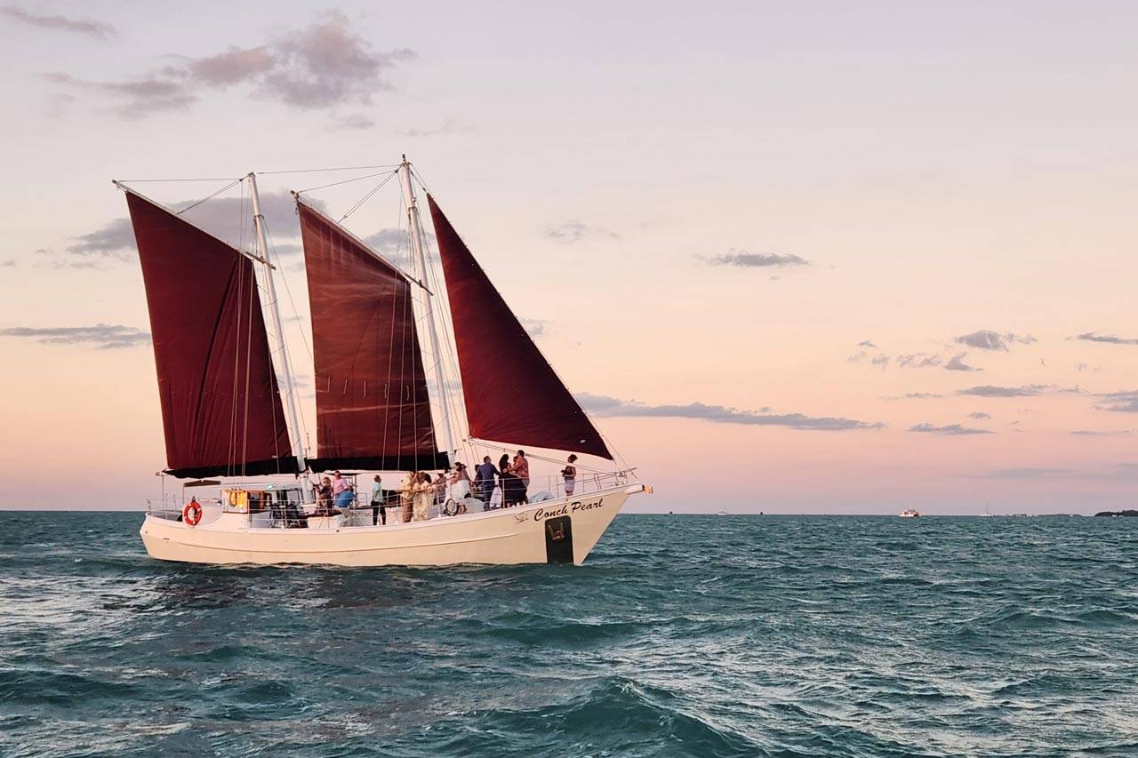 Group aboard a schooner enjoying a sunset cruise in Key West with Danger Charters