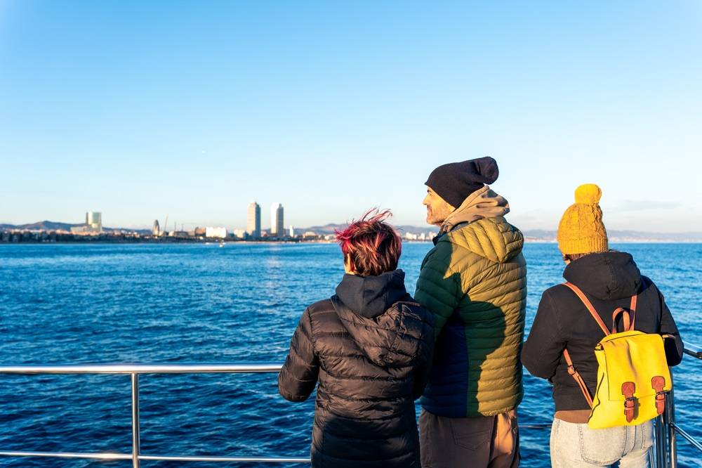 Young people on a boat wearing thick coats